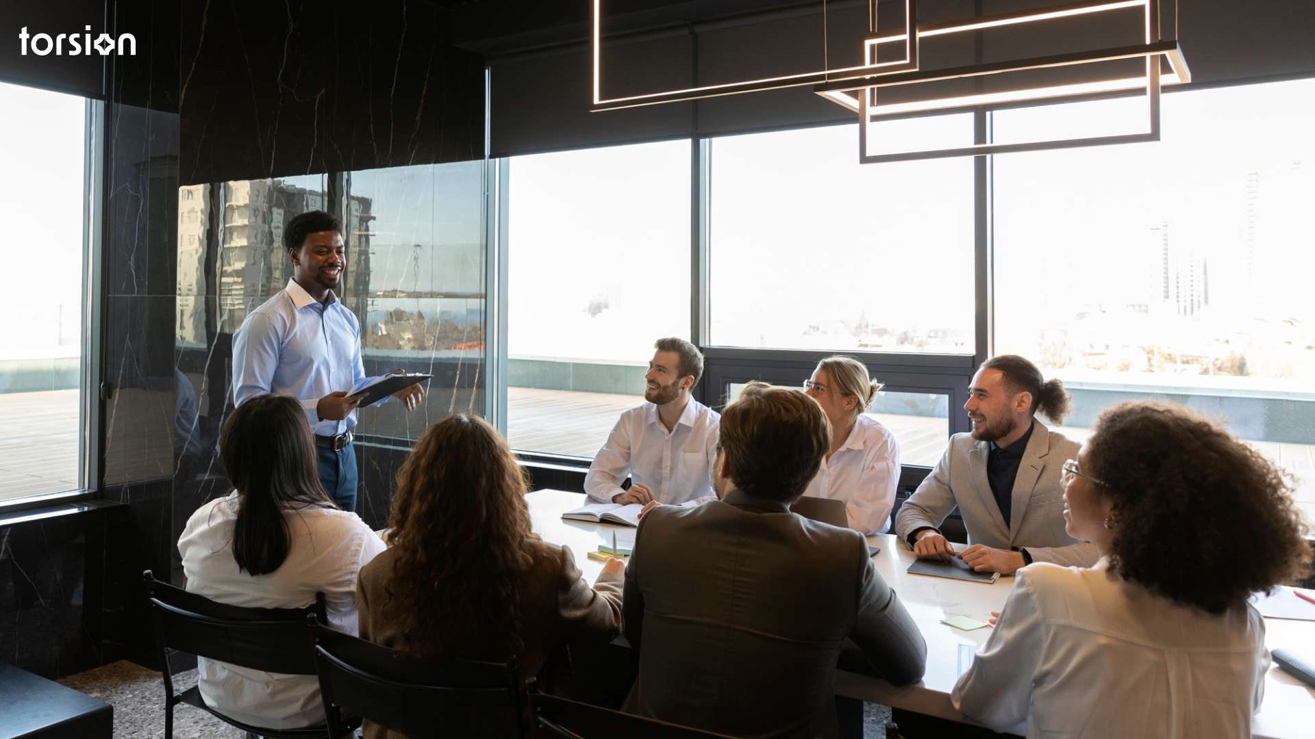 A diverse team of data and business strategists collaborate in a meeting, discussing a plan for building enterprise AI capabilities and bridging the talent gap in healthcare.